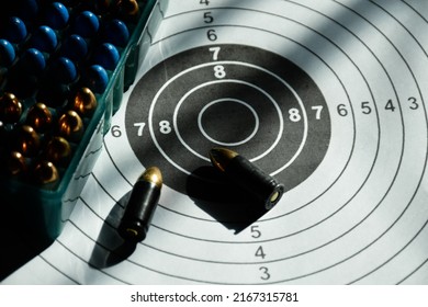 9mm Bullets And 9mm Bullet Case On Shooting Target Paper, Soft And Selective Focus.