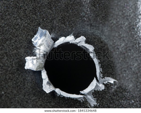 9mm exit bullet
hole in a aluminum car door