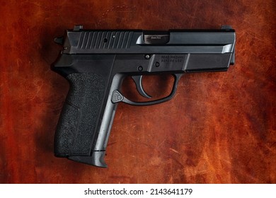 9mm Handgun On Leather Background