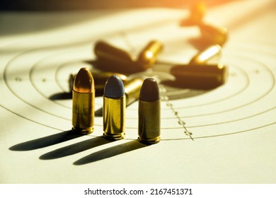 9mm Pistol Bullets On Shooting Target Paper, Soft And Selective Focus.