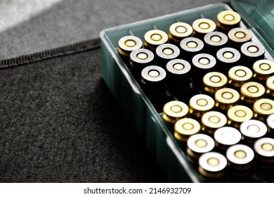 9MM pistol bullets in plastic box on black background, concept for training and practising the gun shooting to protect oneself and security guard around the world, soft and selective focus.