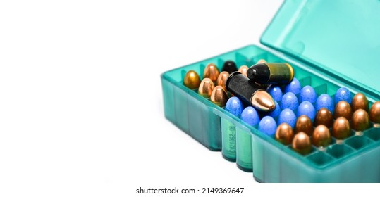 9MM pistol bullets in plastic box on white background, concept for training and practising the gun shooting to do the security guard around the world, soft and selective focus on black bullet above.