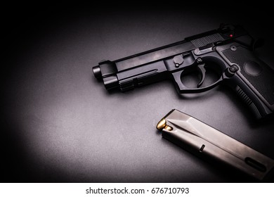  9mm pistol gun on black background