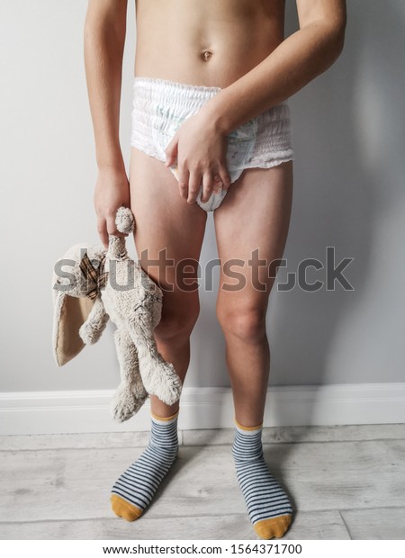 A 9 Year Old Child Is Standing Against A Wall In A Diaper In The Hands Of A Soft Toy The Boy Feels A Sense Of Fear And Shame