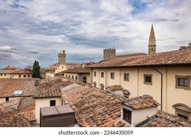 "A cloudy day in Arezzo reveals a stunning cityscape of bell towers, towers, and roofs viewed from the Confraternita dei Laici tower. A unique and breathtaking perspective of the city."