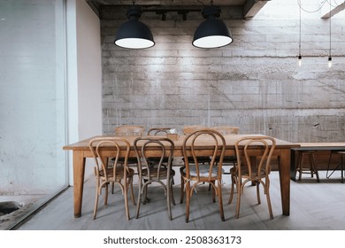 "A cozy, vintage-style cafe with a wooden counter and minimalist decor. The warm interior features modern furniture, coffee cups on a rustic table, and a serene atmosphere, perfect for a relaxed lifes - Powered by Shutterstock