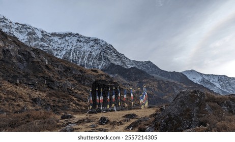 "A serene mountain view adorned with colorful Buddhist prayer flags fluttering in the wind. The snow-capped peaks, clear skies, and vibrant flags create a harmonious blend of nature and spirituality." - Powered by Shutterstock