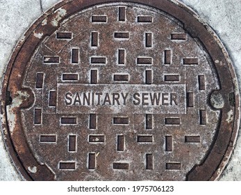 A. very rusty sanitary sewer system manhole cover.