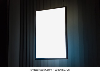 A4 Vertical Glowing Light Box Mockup Template At Night.