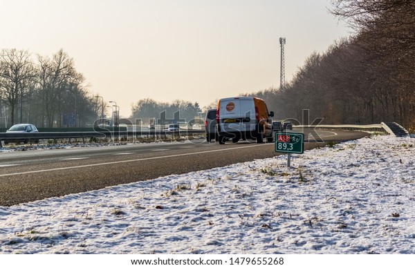 The A58 highway in winter\
season with cars passing by, Roosendaal, The netherlands, 23\
january, 2019