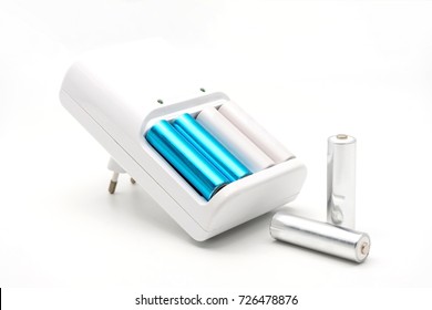 AA batteries rechargeable in accumulator charger, isolated on a white background