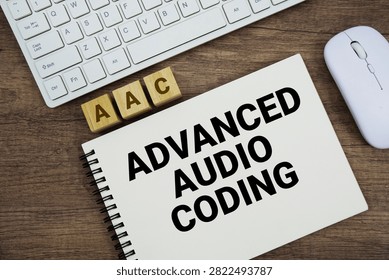 AAC Advanced Audio Coding message with keyboard and optical mouse on wooden background