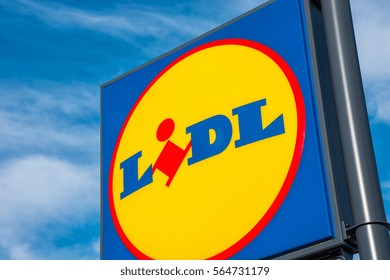 AACHEN, GERMANY JANUARY, 2017: LIDL supermarket chain sign against the blue cloudy sky. LIDL is a German global discount supermarket chain, based in Neckarsulm, Baden-Wuerttemberg, Germany.