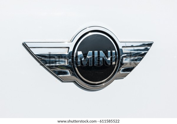 AACHEN, GERMANY MARCH, 2017: Mini cooper car logo\
on white car. It is a model produced by BMW since 2000. BMW is a\
German luxury vehicle, motorcycle, and engine manufacturing company\
founded in 1916.