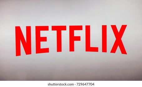 AACHEN, GERMANY OCTOBER, 2017: Netflix logo on a TV screen. Netflix app on Laptop screen. Netflix is an international leading subscription service for watching TV episodes and movies.