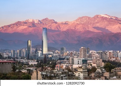 Aaerial view of Santiago skyline at sunset with Costanera skyscraper and Andes Mountains - Santiago, Chile