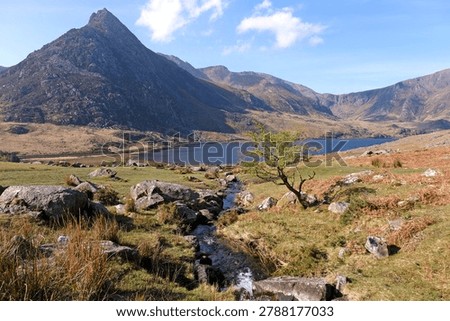 Aaron Lloer stream running down to Llyn Ogwen in Ogwen Valley with Tryfan peak in the background, Eryri National Park, fomaly Snowdonia, North Wales, UK. 