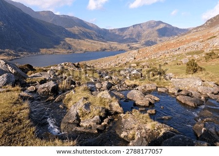 Aaron Lloer stream running down to Llyn Ogwen in Ogwen Valley with the Glyderau  mountain range in the background, Eryri National Park, fomaly Snowdonia, North Wales, UK. 