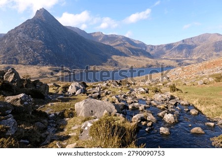 Aaron Lloer stream running down to Llyn Ogwen in Ogwen Valley with Tryfan peak in the background, Eryri National Park, fomaly Snowdonia, North Wales, UK. 