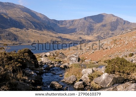 Aaron Lloer stream running down to Llyn Ogwen in Ogwen Valley with the Glyderau  mountain range in the background, Eryri National Park, fomaly Snowdonia, North Wales, UK. 