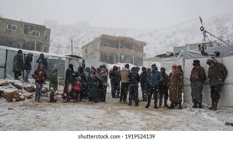 Aarsal, Beqaa Lebanon - 2 18 2021: Refugees In Refuge Camp In E'rsal Waiting For Donations Help At Syrian Lebanese Borders In Winter Snow Storm And Bad Weather Conditions