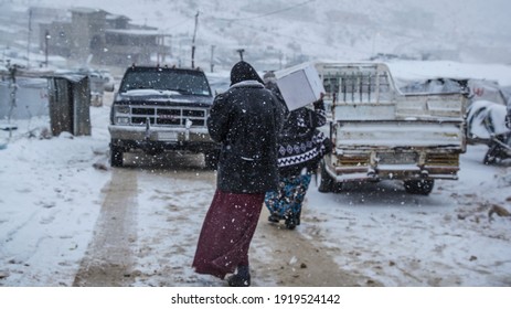 Aarsal, Beqaa Lebanon - 2 18 2021: Refugees In Refuge Camp In E'rsal Waiting For Donations Help At Syrian Lebanese Borders In Winter Snow Storm And Bad Weather Conditions