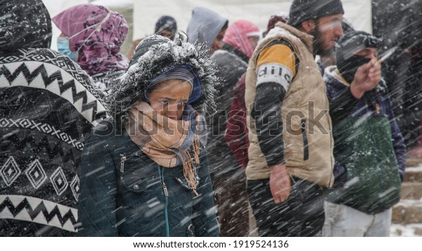 Aarsal, Beqaa\
Lebanon - 2 18 2021: Refugees in Refuge Camp in E\'rsal Waiting for\
Donations Help at Syrian Lebanese Borders in Winter Snow Storm and\
Bad Weather Conditions