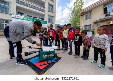 Aba, Sichuan / China - September 20 2018: China Post Has Tested Its Drone Delivery Project In Sichuan Rural Area, Where It Is Warmly Welcomed By A Group Of Kids Under Poverty Line. 