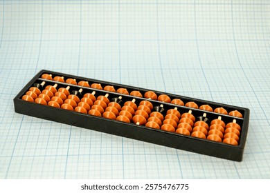 Abacus for mental arithmetic on light blue checkered background. space for text
