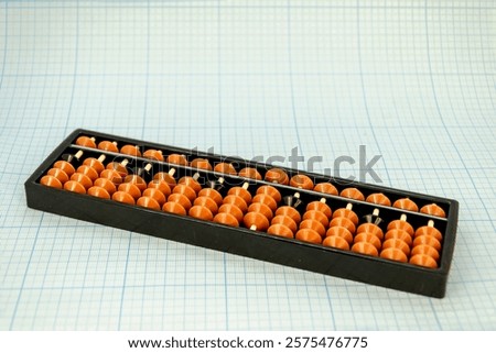 Abacus for mental arithmetic on light blue checkered background. space for text