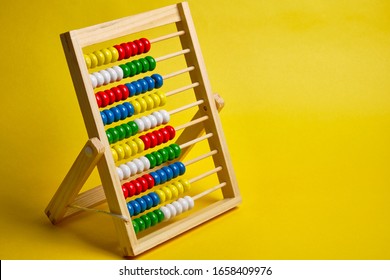 Abacus at yellow background. Shopping, personal finances,  money spendings concept