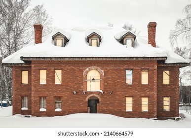 Abadoned country house with boarded up windows in snow winter
