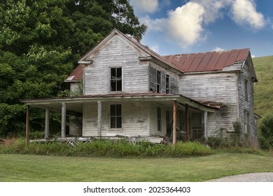 An abadoned farm house stands along a rural road in the Southwest area of the State of Virginia