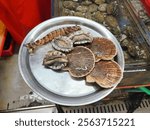 Abalone, oyster and shrimp on the stainless place in Jagalchi market