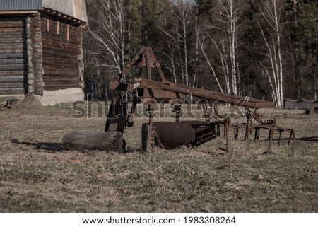 Abandoned agricultural machinery. Old rusty agricultural machines. Sunny day.