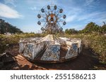 Abandoned amusement park in Japan with a big rusty ferry wheel. It