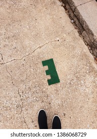 Abandoned Astroturf Letter E Laying On Concrete