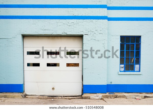 Abandoned\
Auto Repair Shop with Garage Door and\
Window.