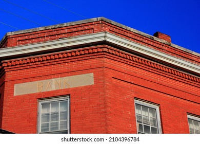 An Abandoned Bank Building, Once Converted To A Restaurant, Sits Forgotten And Boarded Up On A Small Town Square In Texas