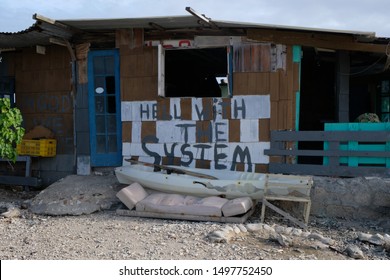 Abandoned Beach Shack With Hell With The System Written On It