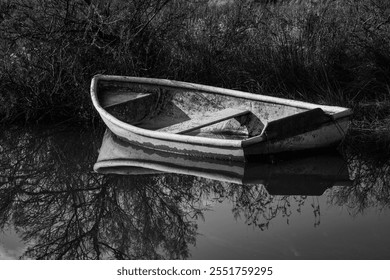 An abandoned boat in a small river or pond - Powered by Shutterstock