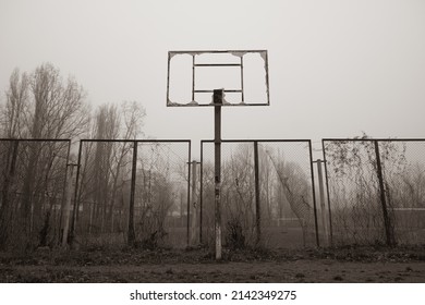 Abandoned broken basketball court in the city park. foggy day - Powered by Shutterstock