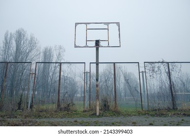 Abandoned broken basketball court in the city park. foggy day - Powered by Shutterstock