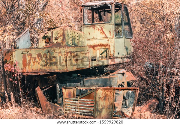 abandoned broken equipment car in the Chernobyl\
forest Ukraine in\
autumn