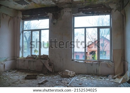 Abandoned building. A beautiful and scary corridor with shabby walls. Interior of an old abandoned building. Light from the window