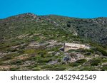 abandoned building on a hill, buildings belonging to an extinct mine in Buggerru, Sardinia, Italy