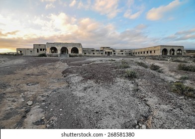 Abandoned Buildings Of A Military Base At Sunset