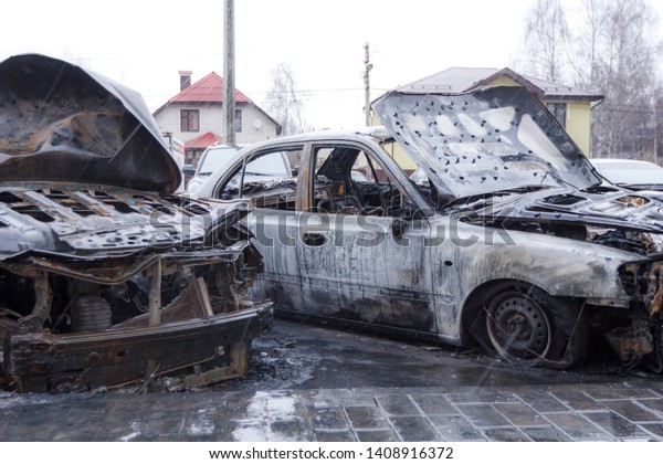 Abandoned and burnt out\
cars in the parking