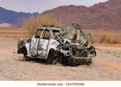 Abandoned Car In Desert Landscape