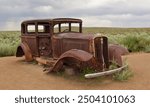 Abandoned car in the desert next to route 66 classic americana